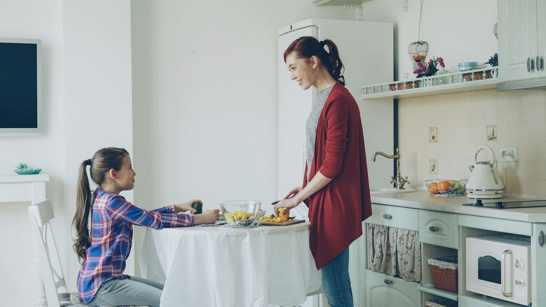 Mother serving her daughter breakfast in a bright kitchen